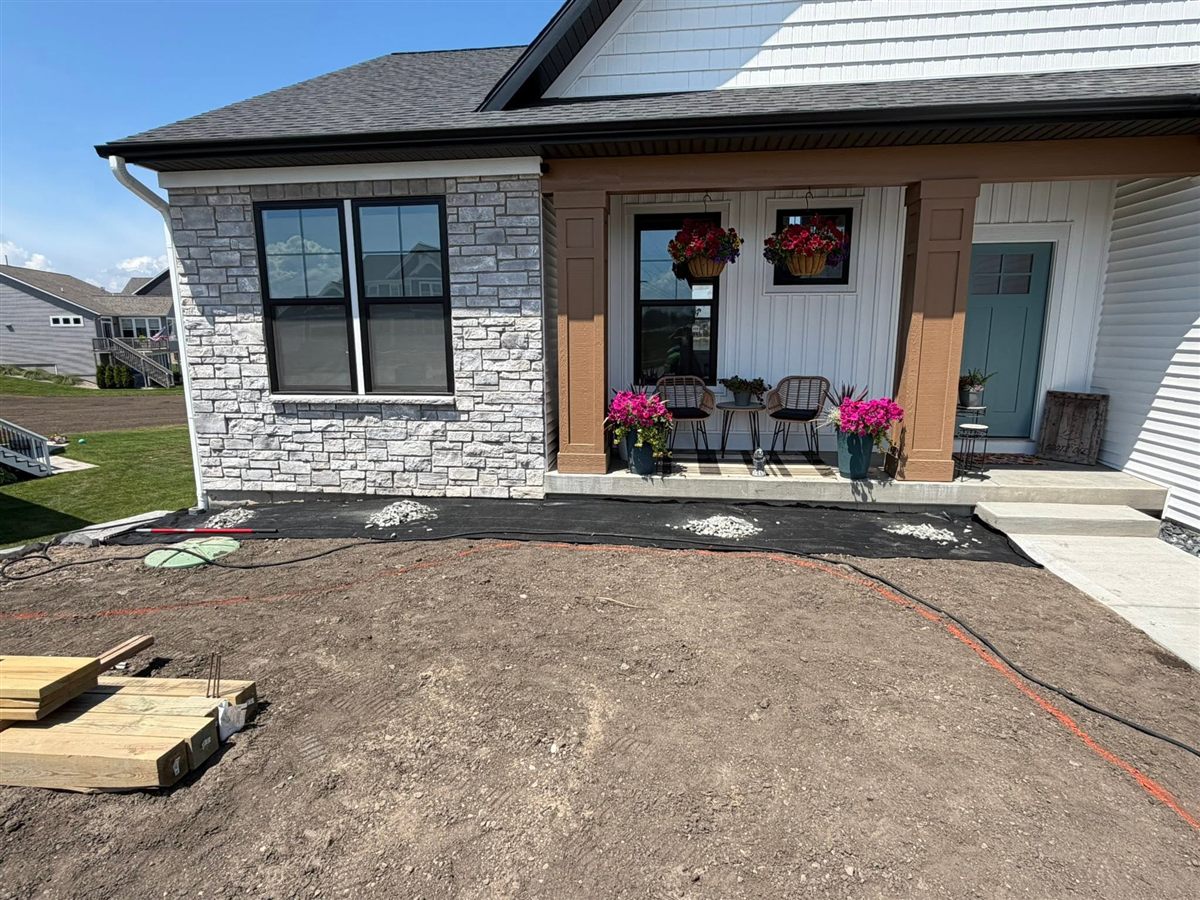 Before: bare graded soil in front of the house
