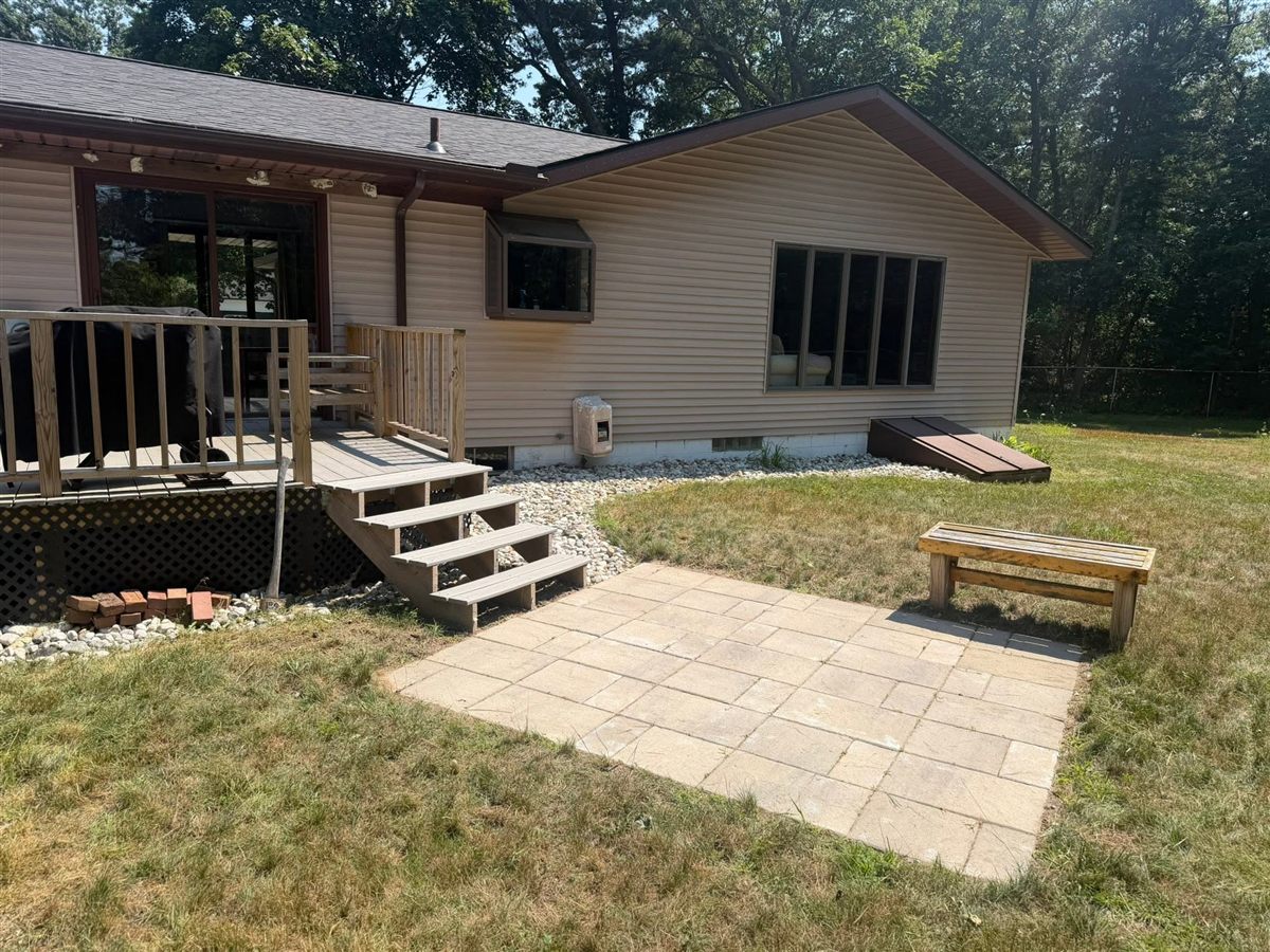 After: clean paver patio with a bench
