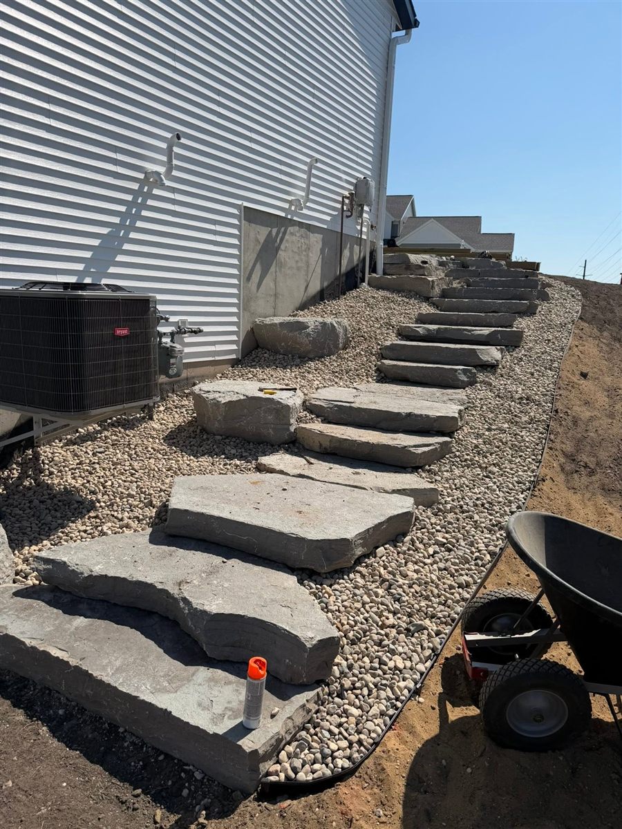 After: finished natural stone steps up a slope